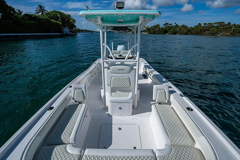 Slide: The Image of 2020 Caymas 28 HB boat on water, featuring spacious seating and sleek design. - 13