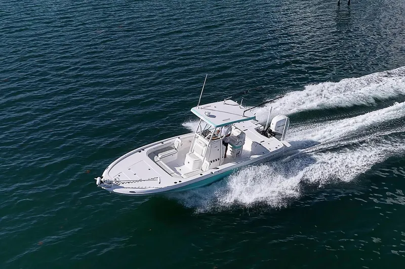 Slide: The Image of 2020 Caymas 28 HB boat cruising on open water, creating a wake. - 5