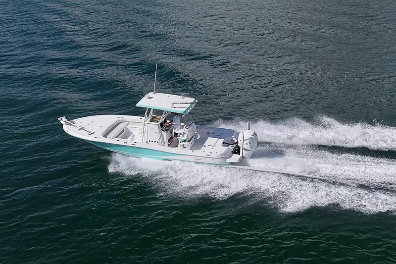 Slide: The Image of 2020 Caymas 28 HB boat cruising on open water, showcasing sleek design and performance. - 7
