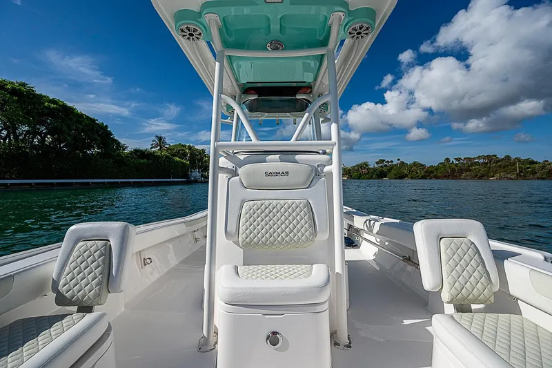 Slide: The Image of 2020 Caymas 28 HB boat interior with quilted seats, on a sunny day by the water. - 14