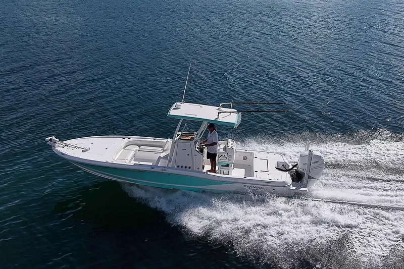 Slide: The Image of 2020 Caymas 28 HB boat cruising on open water, showcasing sleek design and performance. - 4