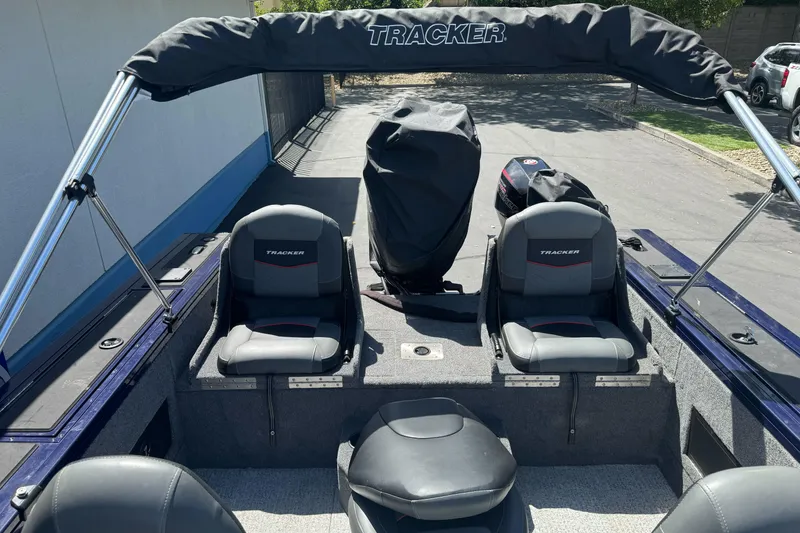 Slide: The Image of 2024 Tracker Targa V-18 Combo boat interior with seating and covered engine. - 17