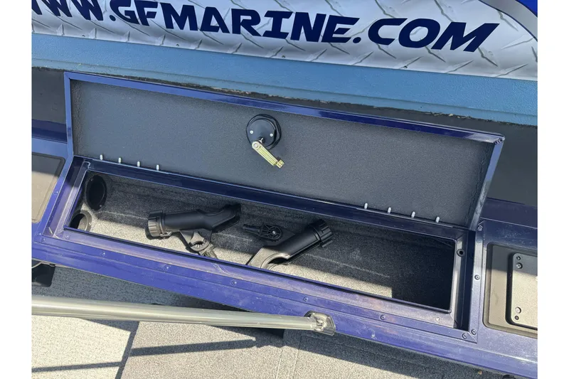 Slide: The Image of Open storage compartment on 2024 Tracker Targa V-18 Combo boat with fishing rod holders. - 21