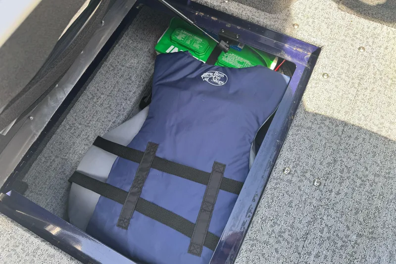 Slide: The Image of Storage compartment in 2024 Tracker Targa V-18 Combo with life jacket and supplies. - 25