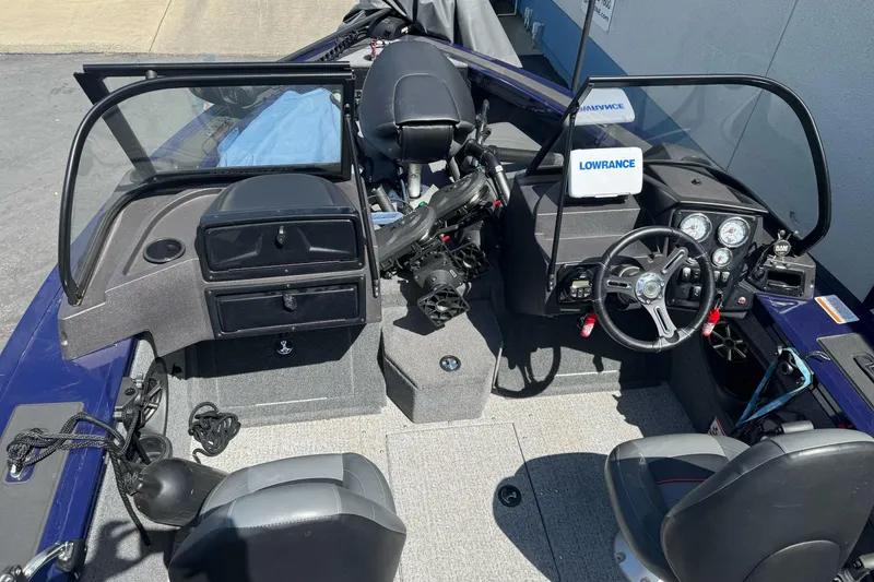 Slide: The Image of 2024 Tracker Targa V-18 Combo boat interior with steering wheel and dashboard controls. - 24