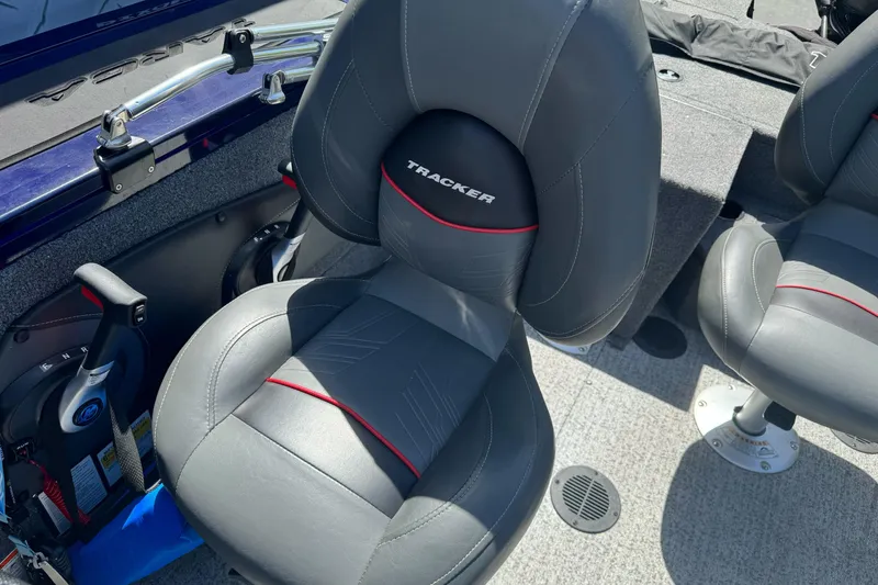 Slide: The Image of 2024 Tracker Targa V-18 Combo boat interior with gray seats and red accents. - 16