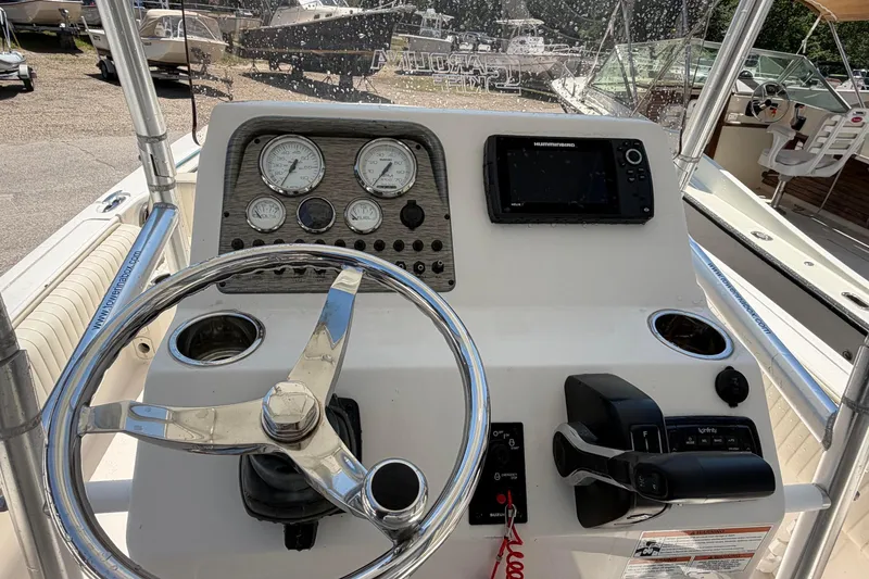 Slide: The Image of 2018 Carolina Skiff 22 Ultra Elite boat console with steering wheel and navigation equipment. - 3