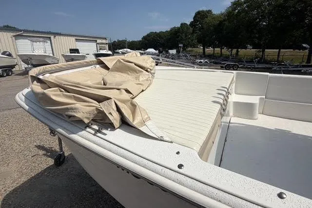 Slide: The Image of 2018 Carolina Skiff 22 Ultra Elite boat with beige cover, parked outdoors. - 4