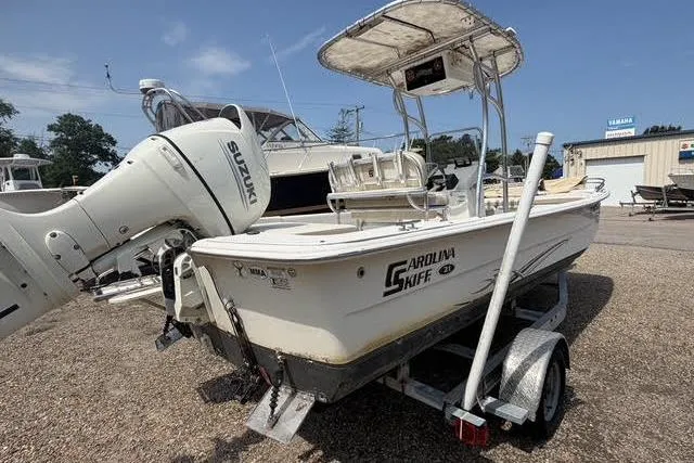 Slide: The Image of 2018 Carolina Skiff 22 Ultra Elite boat on trailer with Suzuki outboard motor. - 11