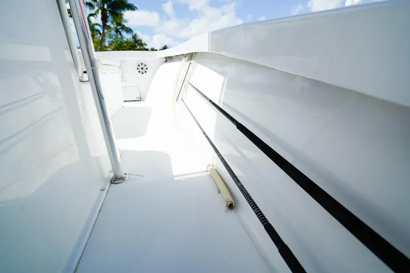 Slide: The Image of 1977 Scarborough 27 CC boat deck with sleek white finish and fishing rod holder. - 14