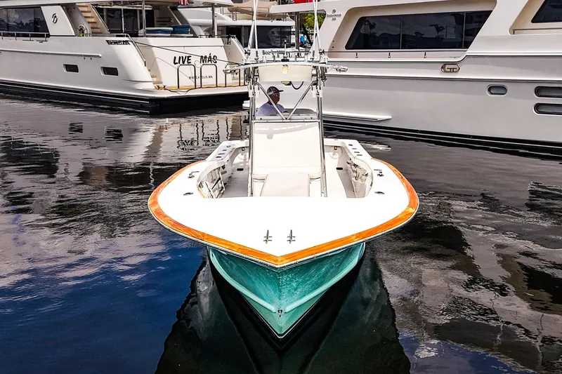 Slide: The Image of 1977 Scarborough 27 CC boat docked, surrounded by luxury yachts. - 22