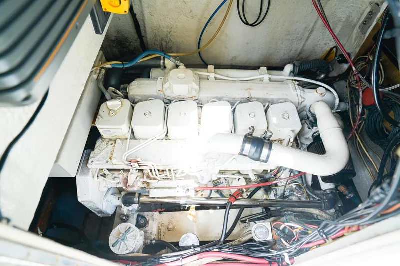 Slide: The Image of Engine compartment of a 1977 Scarborough 27 CC boat, showcasing detailed mechanical components. - 21