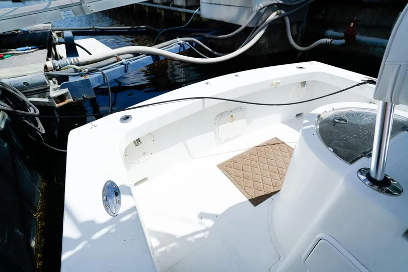 Slide: The Image of 1977 Scarborough 27 CC boat interior at dock, featuring clean white deck. - 3