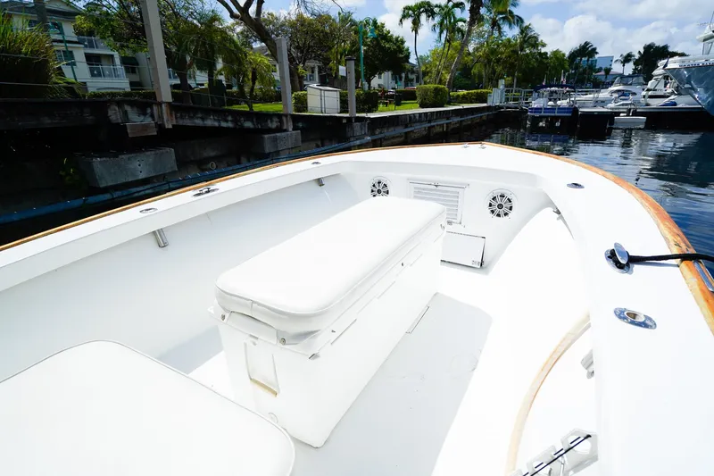 Slide: The Image of 1977 Scarborough 27 CC boat interior with white seating, docked near palm trees. - 17