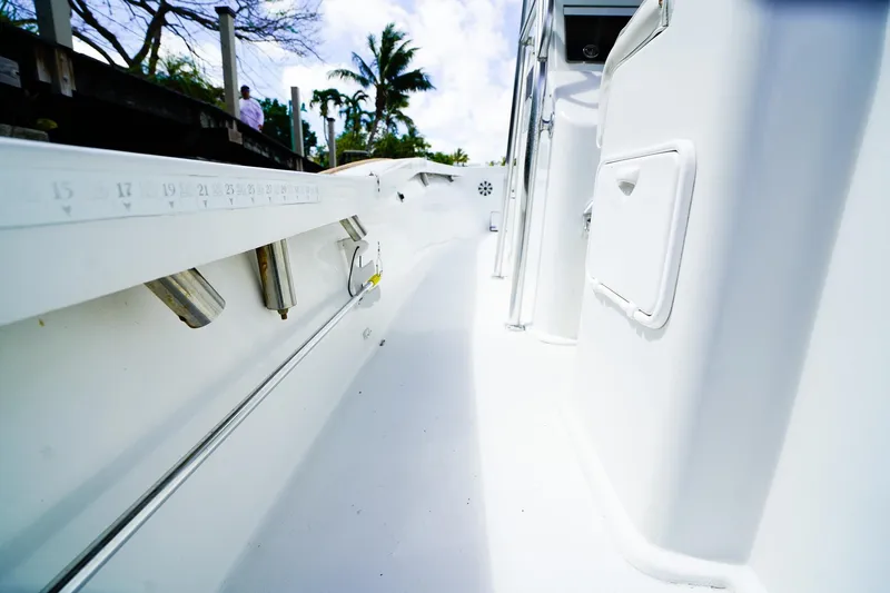 Slide: The Image of 1977 Scarborough 27 CC boat interior with white deck and storage compartments. - 6