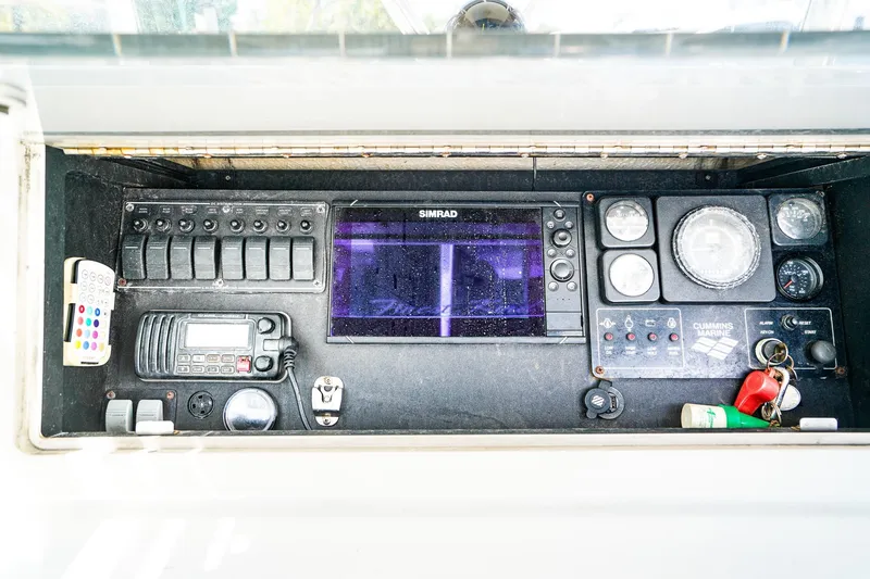 Slide: The Image of Control panel of a 1977 Scarborough 27 CC boat with navigation and communication equipment. - 12