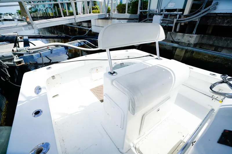 Slide: The Image of 1977 Scarborough 27 CC boat interior with white seating and dockside view. - 8