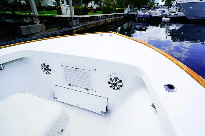 Slide: The Image of 1977 Scarborough 27 CC boat interior with speakers, docked at marina. - 20