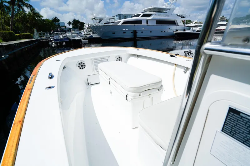 Slide: The Image of 1977 Scarborough 27 CC boat interior at marina, featuring white seating and wooden trim. - 15