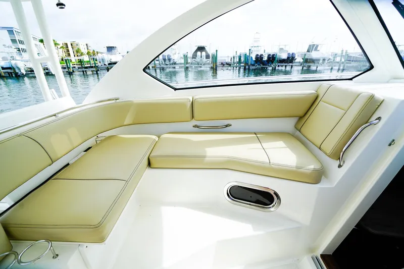 Slide: The Image of Luxurious seating area on 2020 Pursuit OS 325 Offshore boat, docked at marina. - 20