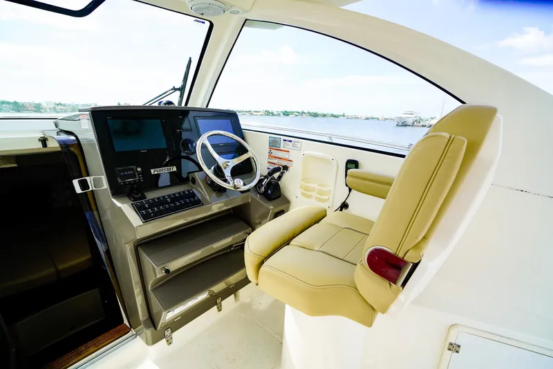 Slide: The Image of 2020 Pursuit OS 325 Offshore helm with modern controls and comfortable seating. - 21