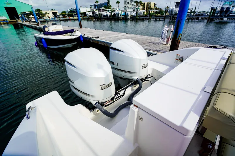 Slide: The Image of 2020 Pursuit OS 325 Offshore boat with twin Yamaha 300 engines docked at marina. - 5