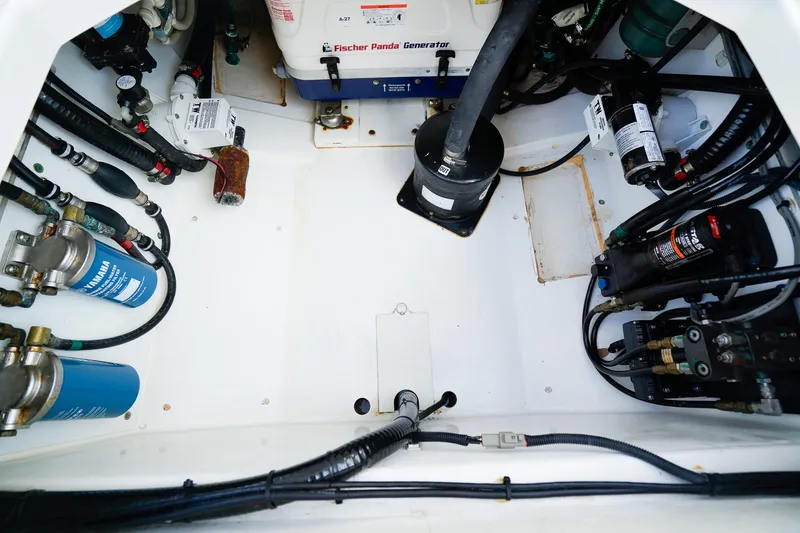 Slide: The Image of Engine compartment of a 2020 Pursuit OS 325 Offshore boat with visible generator and components. - 16