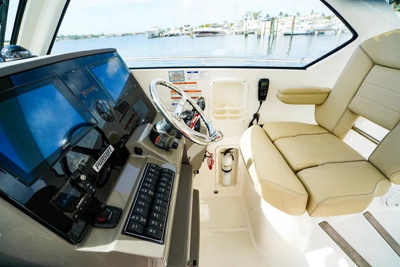 Slide: The Image of 2020 Pursuit OS 325 Offshore helm with modern controls and comfortable seating. - 22
