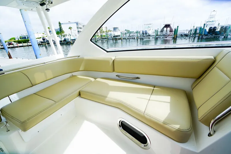 Slide: The Image of Luxurious seating area on 2020 Pursuit OS 325 Offshore boat, docked at marina. - 19