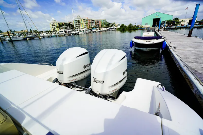 Slide: The Image of 2020 Pursuit OS 325 Offshore boat with twin Yamaha 300 engines docked at marina. - 6