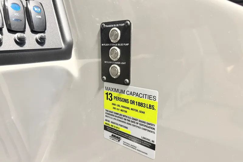 Slide: The Image of Control panel and capacity label on 2026 Manitou Encore Sl SHP575 boat. - 20