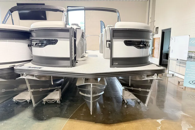 Slide: The Image of 2026 Manitou Encore SL SHP575 pontoon boat displayed indoors. - 6