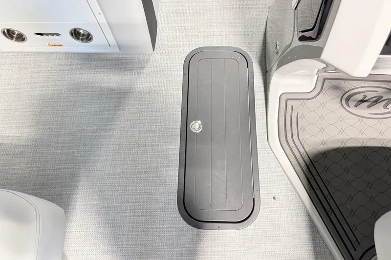 Slide: The Image of 2026 Manitou Encore SL SHP575 boat interior with sleek flooring and storage compartment. - 4