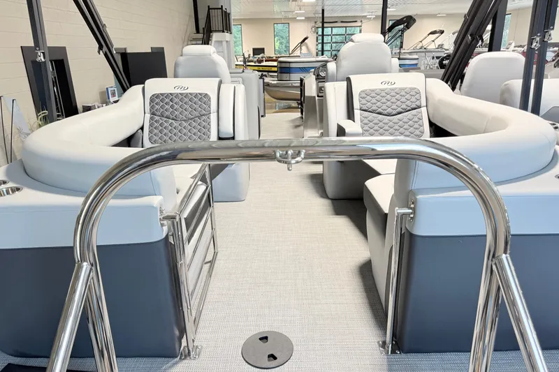 Slide: The Image of 2026 Manitou Encore SL SHP575 pontoon boat interior with luxurious seating and modern design. - 7