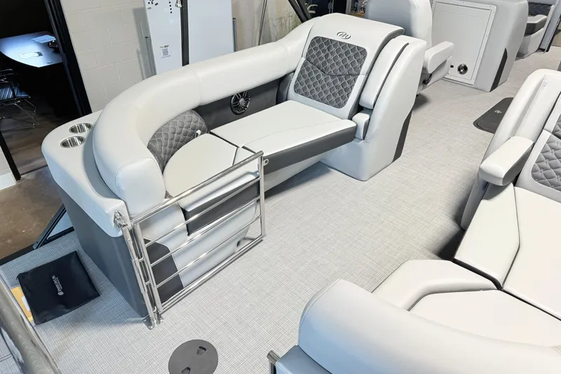 Slide: The Image of Luxurious seating on 2026 Manitou Encore SL SHP575 pontoon boat interior. - 10