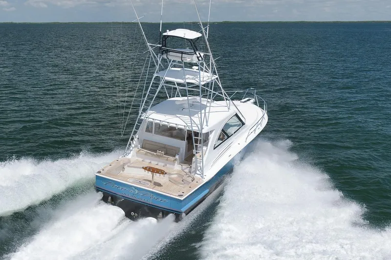 Slide: The Image of 2023 Hatteras GT45X Tower yacht cruising swiftly on open water. - 6