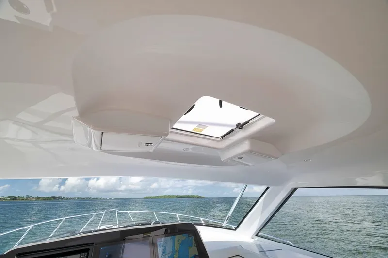 Slide: The Image of Interior view of 2023 Hatteras GT45X Tower yacht with open hatch and ocean backdrop. - 31