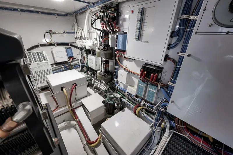 Slide: The Image of Engine room of 2023 Hatteras GT45X Tower, showcasing electrical systems and wiring. - 47