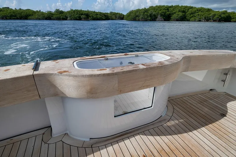 Slide: The Image of 2023 Hatteras GT45X Tower yacht deck with wooden finish and ocean view. - 16