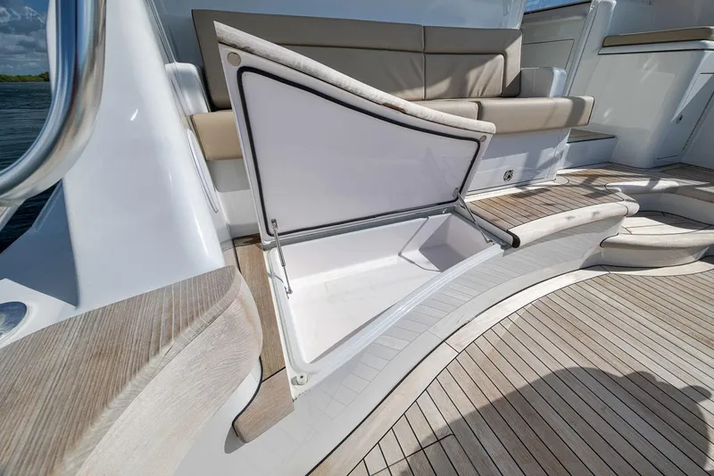 Slide: The Image of 2023 Hatteras GT45X Tower yacht with open storage compartment and teak deck. - 19
