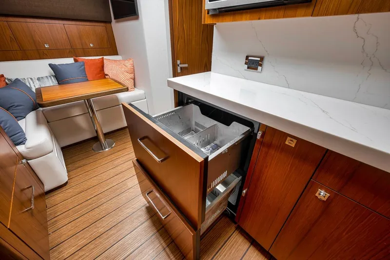 Slide: The Image of Luxurious interior of 2023 Hatteras GT45X Tower yacht with modern kitchen and seating area. - 40
