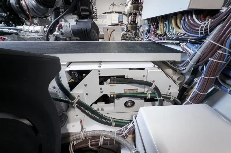 Slide: The Image of Engine room of 2023 Hatteras GT45X Tower with complex wiring and machinery. - 51