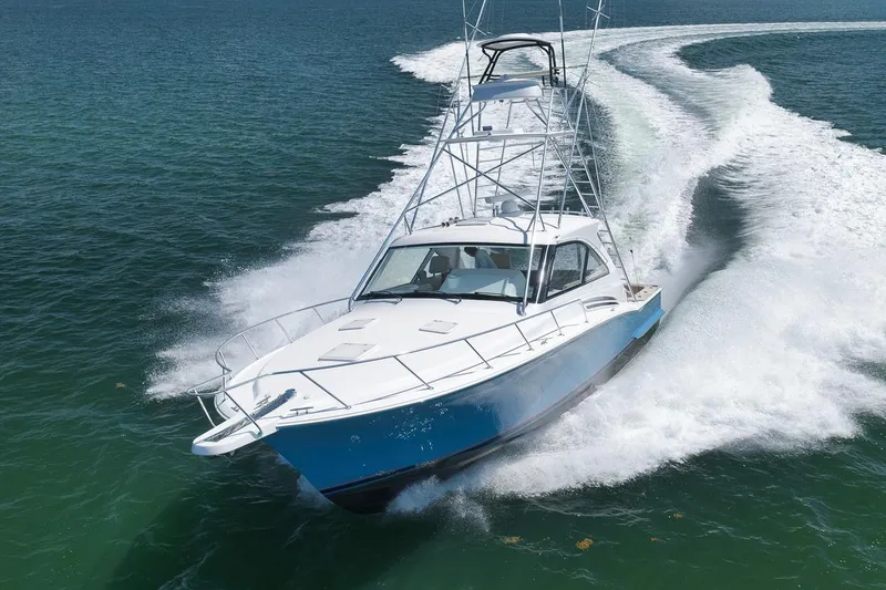 Slide: The Image of 2023 Hatteras GT45X Tower yacht cruising swiftly on open water. - 5