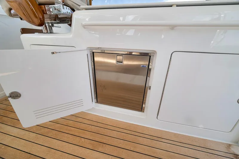 Slide: The Image of 2023 Hatteras GT45X Tower yacht interior with open storage compartment and stainless steel appliance. - 28