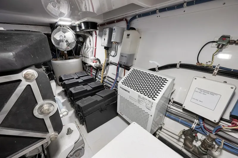 Slide: The Image of Engine room of 2023 Hatteras GT45X Tower with equipment and wiring. - 48