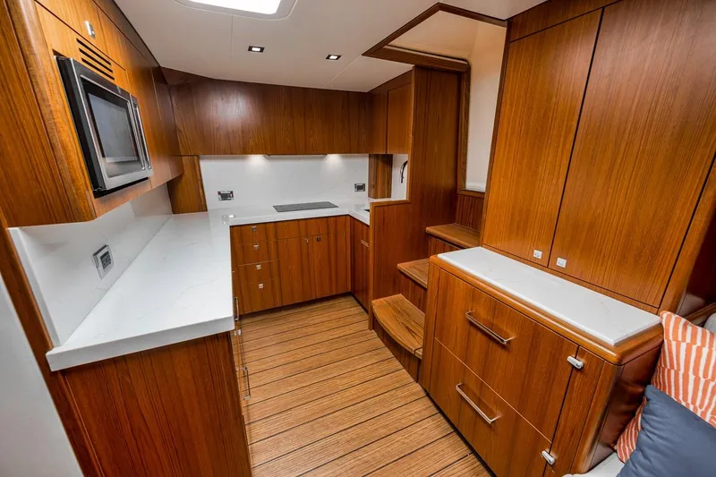 Slide: The Image of Luxurious 2023 Hatteras GT45X Tower yacht interior with sleek wood cabinetry and modern appliances. - 35