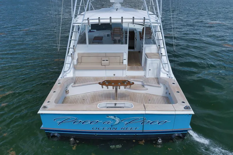 Slide: The Image of 2023 Hatteras GT45X Tower yacht on water, featuring spacious deck and elegant design. - 12