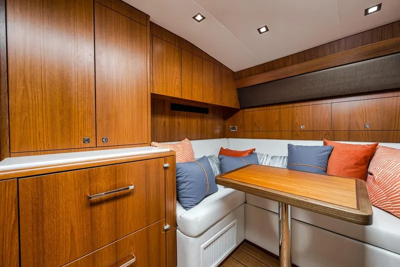 Slide: The Image of Luxurious interior of 2023 Hatteras GT45X Tower yacht with wood cabinetry and cozy seating area. - 38