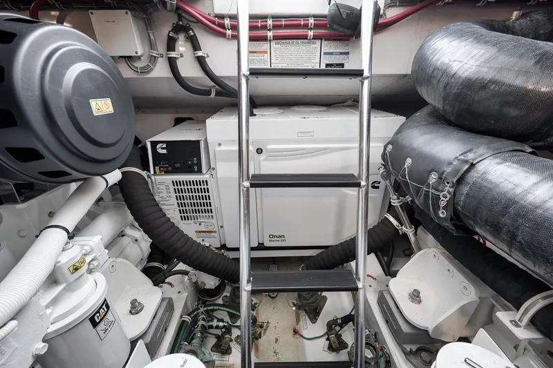 Slide: The Image of Engine room of 2023 Hatteras GT45X Tower yacht, featuring Cummins and Onan equipment. - 53