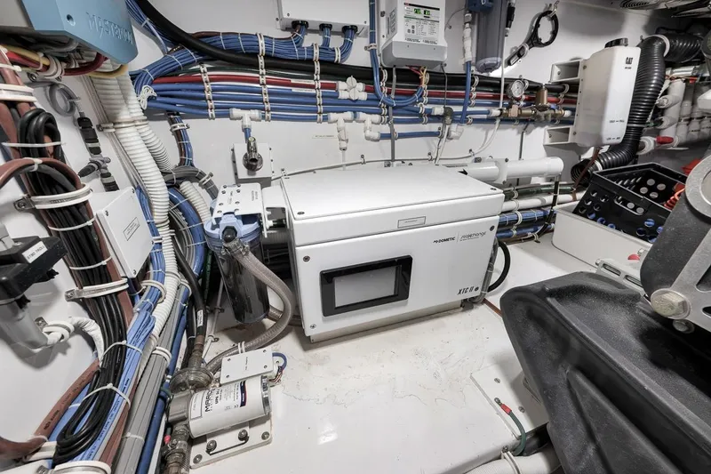 Slide: The Image of Engine room of 2023 Hatteras GT45X Tower with advanced equipment and wiring. - 50